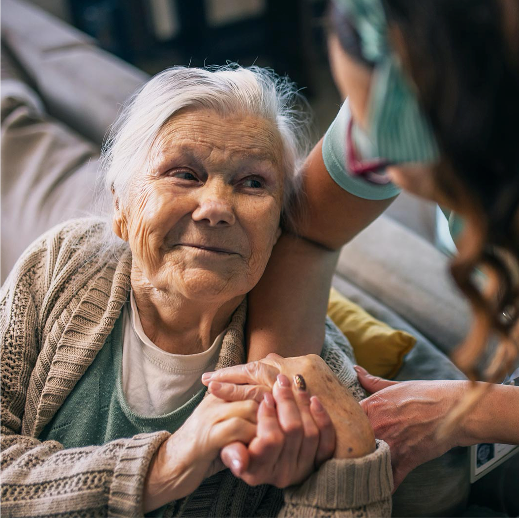 a man and woman smiling and holding a cup of coffee
