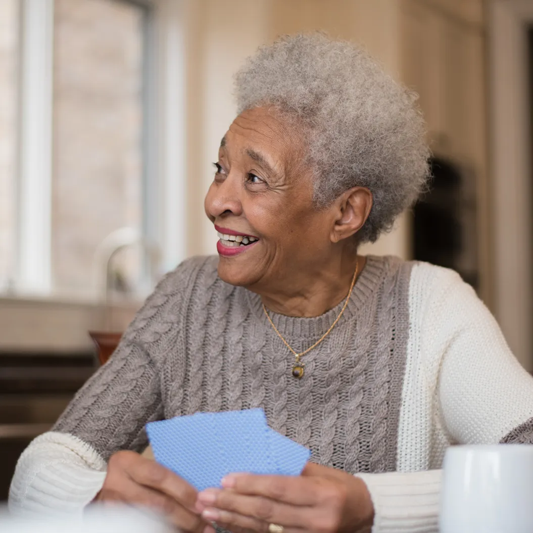 a man and woman smiling and holding a cup of coffee